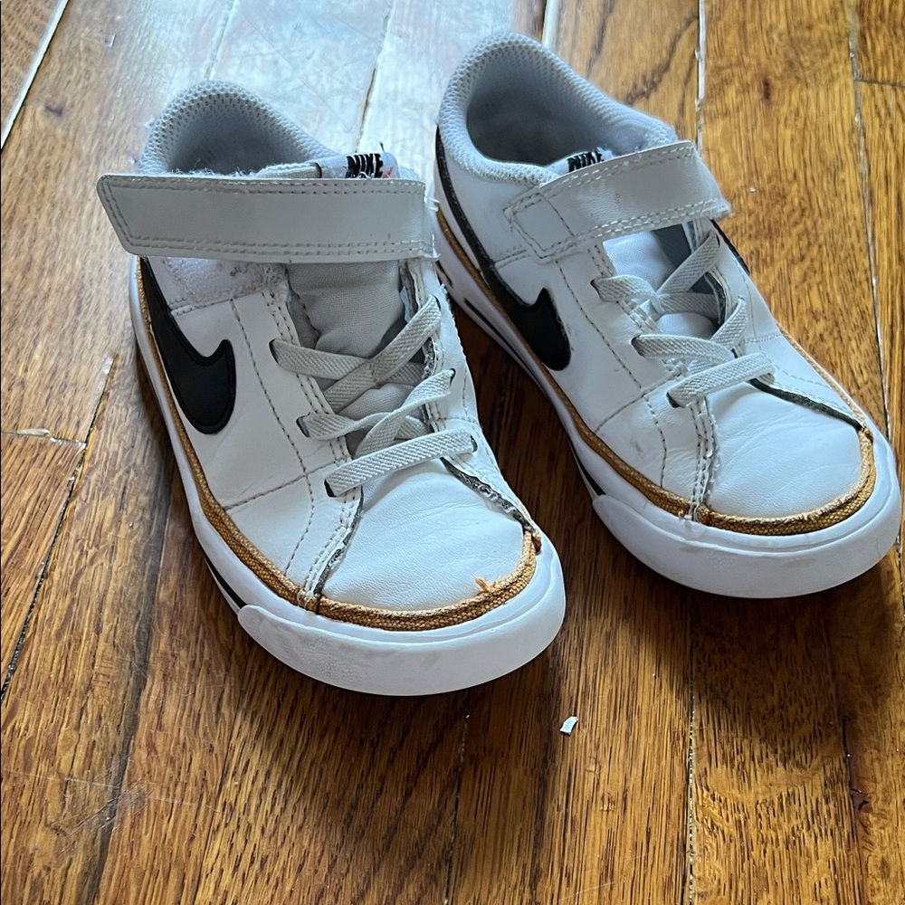 Nike Kids White Sneakers with Black Swoosh and Gold Trim